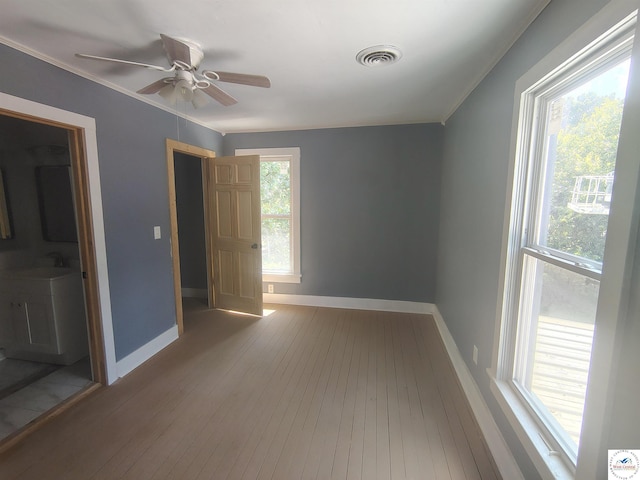 1105 Lay Ave, Warsaw, MO 65355 - spare room with wood-type flooring, a ceiling fan, and ornamental molding