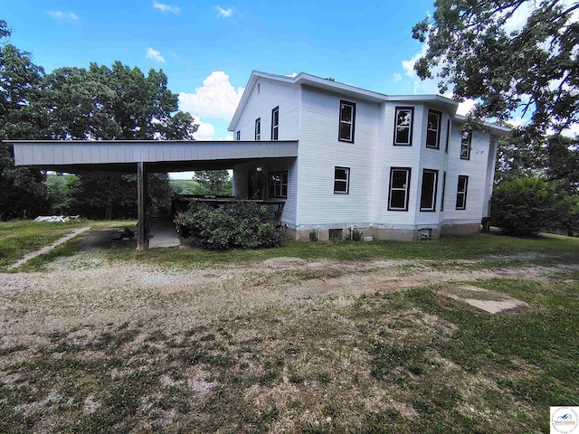 1105 Lay Ave, Warsaw, MO 65355 - view of side of property with driveway and a carport