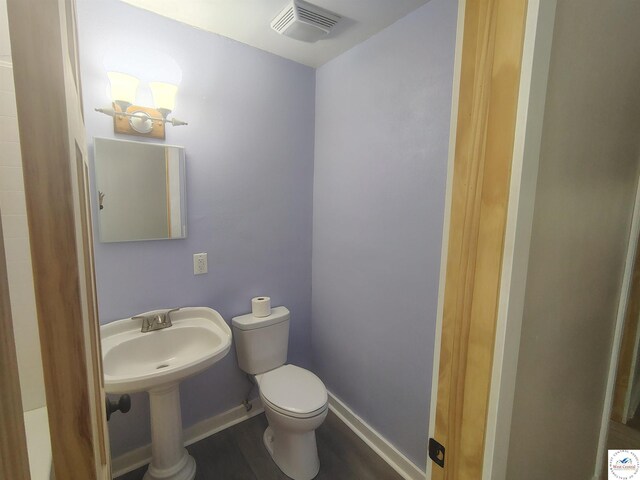 1105 Lay Ave, Warsaw, MO 65355 - bathroom featuring toilet and wood finished floors