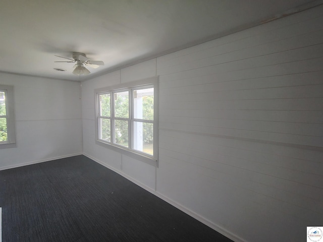 1105 Lay Ave, Warsaw, MO 65355 - spare room with a ceiling fan and dark colored carpet