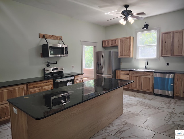 1105 Lay Ave, Warsaw, MO 65355 - kitchen with appliances with stainless steel finishes, light marble finish floors, healthy amount of natural light, and a ceiling fan