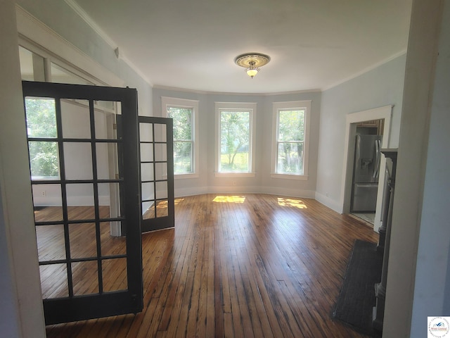 1105 Lay Ave, Warsaw, MO 65355 - empty room featuring crown molding, healthy amount of natural light, and hardwood / wood-style floors