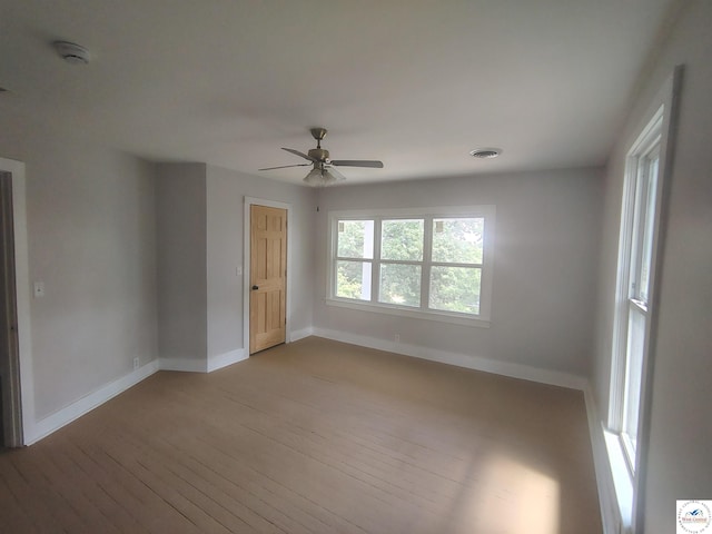 1105 Lay Ave, Warsaw, MO 65355 - spare room featuring wood-type flooring, a ceiling fan, and a smoke detector