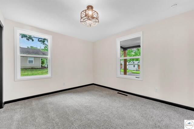 1401 S Park Ave, Sedalia, MO 65301 - carpeted empty room featuring healthy amount of natural light and baseboards