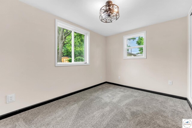 1401 S Park Ave, Sedalia, MO 65301 - carpeted empty room featuring baseboards