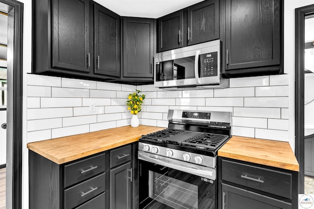 1401 S Park Ave, Sedalia, MO 65301 - kitchen featuring wooden counters, appliances with stainless steel finishes, and decorative backsplash