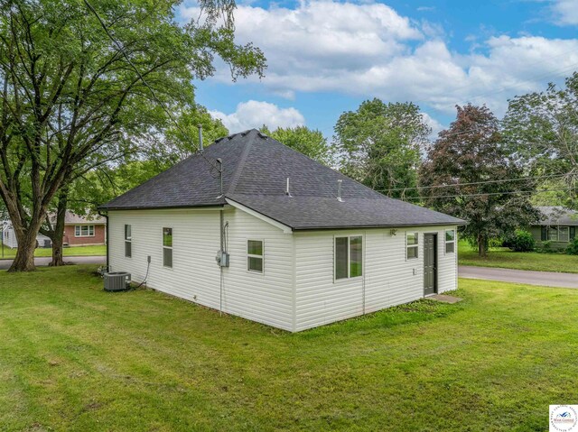 1401 S Park Ave, Sedalia, MO 65301 - view of property exterior with roof with shingles, central air condition unit, and a lawn