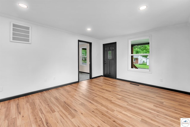 1401 S Park Ave, Sedalia, MO 65301 - empty room featuring crown molding, light wood-style flooring, baseboards, and recessed lighting