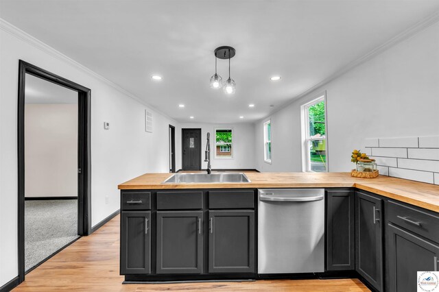 1401 S Park Ave, Sedalia, MO 65301 - kitchen with stainless steel dishwasher, wood counters, a sink, crown molding, and light wood-type flooring
