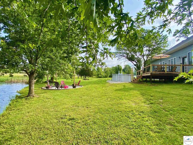 165 NE 100th Rd, Clinton, MO 64735 - view of yard featuring a fire pit and a deck with water view