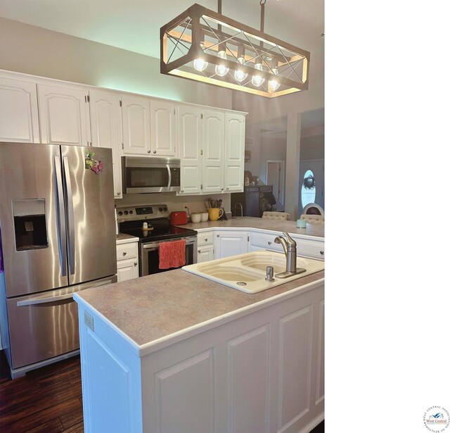 165 NE 100th Rd, Clinton, MO 64735 - kitchen with a sink, light countertops, white cabinets, appliances with stainless steel finishes, and dark wood finished floors