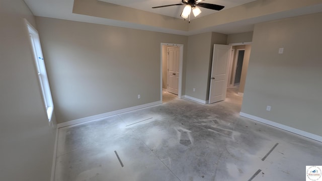 unfurnished bedroom with baseboards, a ceiling fan, and unfinished concrete flooring