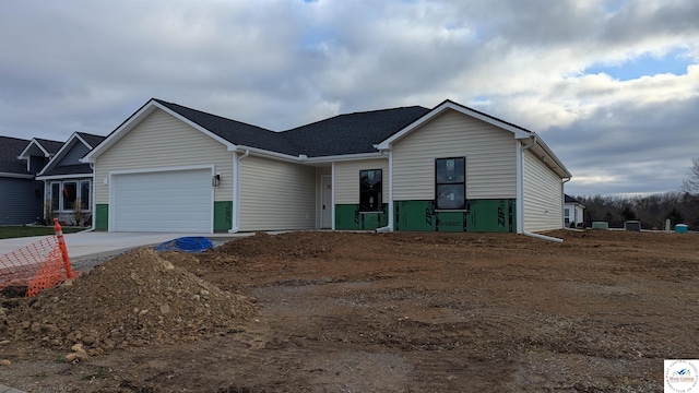single story home featuring concrete driveway and a garage