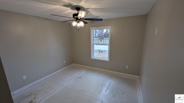 unfurnished room with baseboards, a ceiling fan, and concrete flooring