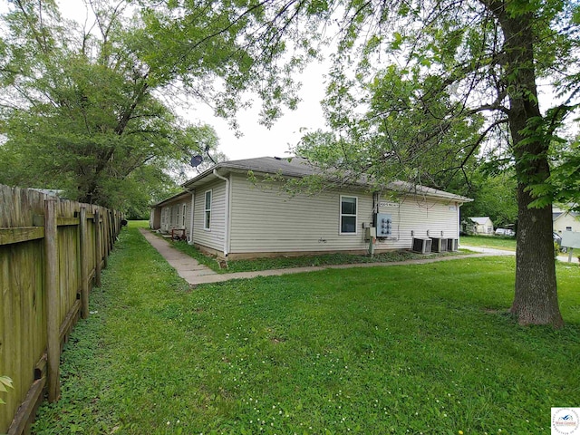 206 N Ohio St, Chilhowee, MO 64733 - back of house featuring fence, central AC unit, and a yard