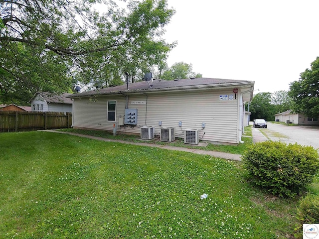 206 N Ohio St, Chilhowee, MO 64733 - rear view of house featuring fence, a yard, and central air condition unit