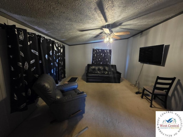 living area with a ceiling fan, carpet floors, and a textured ceiling