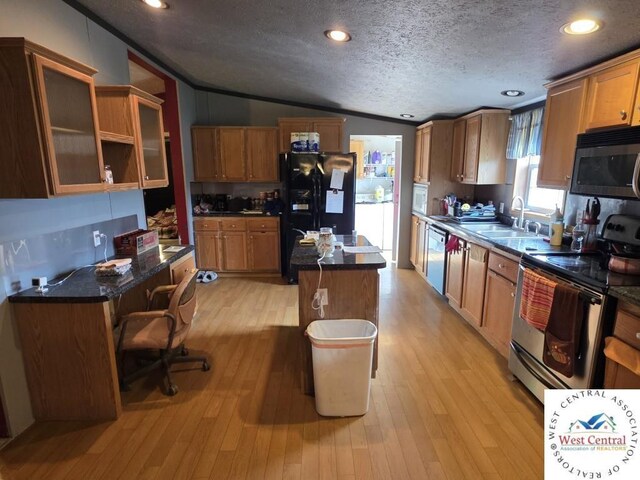 253 SW 950th Rd, Chilhowee, MO 64733 - kitchen with black appliances, lofted ceiling, a textured ceiling, a kitchen island, and brown cabinets