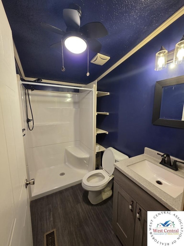 full bathroom with toilet, a stall shower, a ceiling fan, visible vents, and wood finished floors