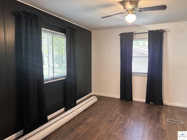 25609 Honey Bear Loop, Warsaw, MO 65355 - empty room with wood finished floors, healthy amount of natural light, ceiling fan, and a baseboard heating unit