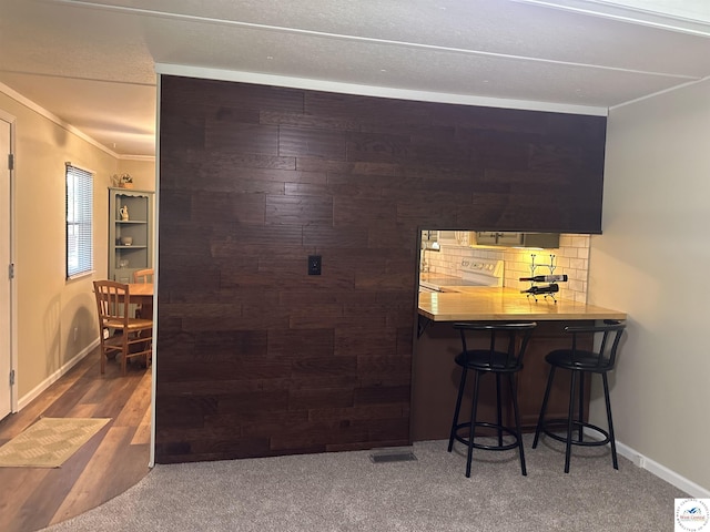 25609 Honey Bear Loop, Warsaw, MO 65355 - bar with ornamental molding, electric range, tasteful backsplash, and carpet flooring