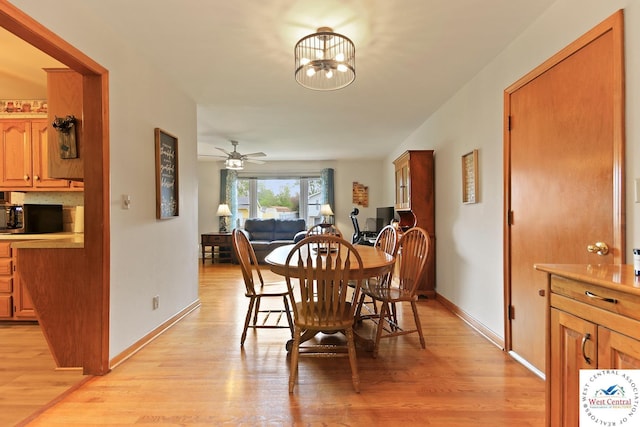 904 Leone Ave, Sedalia, MO 65301 - dining room with baseboards, light wood-style flooring, and ceiling fan with notable chandelier