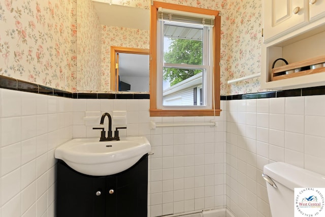 904 Leone Ave, Sedalia, MO 65301 - bathroom with wallpapered walls, toilet, and a wainscoted wall