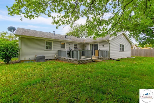 904 Leone Ave, Sedalia, MO 65301 - rear view of house with fence, a deck, central AC, and a lawn
