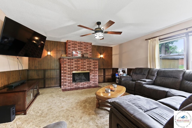 904 Leone Ave, Sedalia, MO 65301 - carpeted living room featuring a ceiling fan, wooden walls, and a fireplace