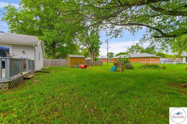904 Leone Ave, Sedalia, MO 65301 - view of yard featuring a fenced backyard, an outdoor structure, a shed, and a playground