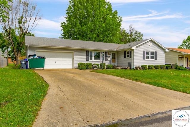 904 Leone Ave, Sedalia, MO 65301 - ranch-style home with concrete driveway, a front lawn, and an attached garage