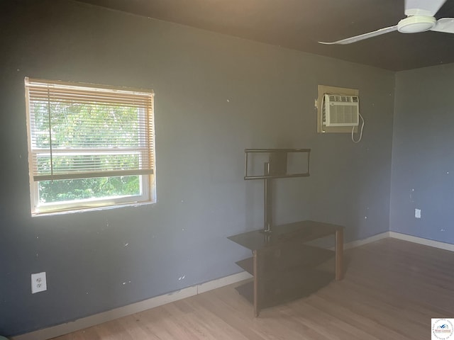 17254 Walnut Rd, Warsaw, MO 65355 - spare room with wood finished floors, ceiling fan, plenty of natural light, and a wall mounted air conditioner