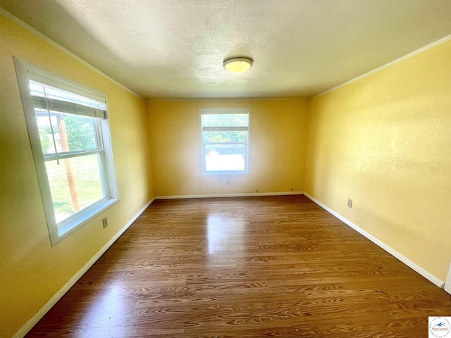 17254 Walnut Rd, Warsaw, MO 65355 - unfurnished room with ornamental molding, wood finished floors, and a textured ceiling