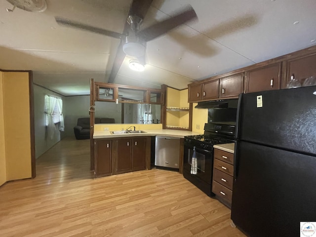 17254 Walnut Rd, Warsaw, MO 65355 - kitchen with black appliances, light wood-type flooring, under cabinet range hood, light countertops, and vaulted ceiling