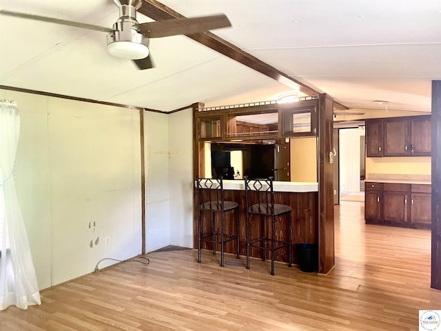 17254 Walnut Rd, Warsaw, MO 65355 - kitchen featuring light wood-style flooring, a breakfast bar, light countertops, and ceiling fan