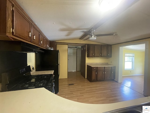 17254 Walnut Rd, Warsaw, MO 65355 - kitchen featuring black gas range, under cabinet range hood, ceiling fan, light wood-type flooring, and lofted ceiling