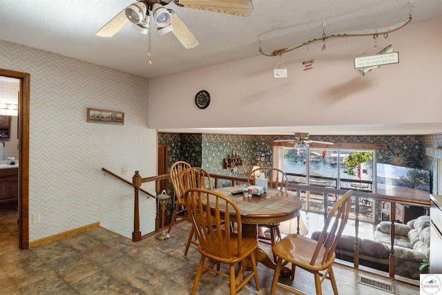 28174 Apex Ave, Warsaw, MO 65355 - dining room with ceiling fan, wallpapered walls, baseboards, and a textured ceiling