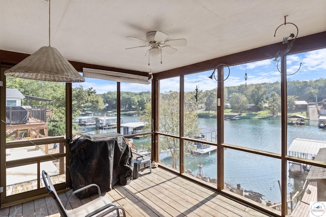28174 Apex Ave, Warsaw, MO 65355 - sunroom with a water view, plenty of natural light, wood-type flooring, view of wooded area, and expansive windows