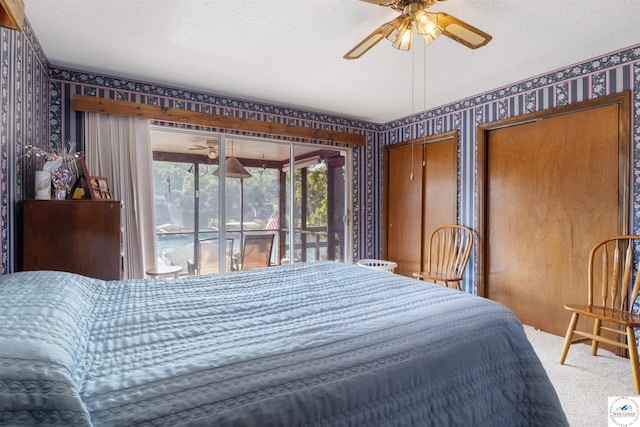 28174 Apex Ave, Warsaw, MO 65355 - bedroom with wallpapered walls, carpet flooring, access to outside, a textured ceiling, and multiple closets