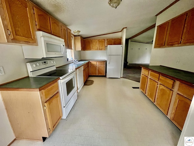 202 Cleveland St, Versailles, MO 65084 - kitchen with white appliances, vaulted ceiling, dark countertops, brown cabinets, and a sink