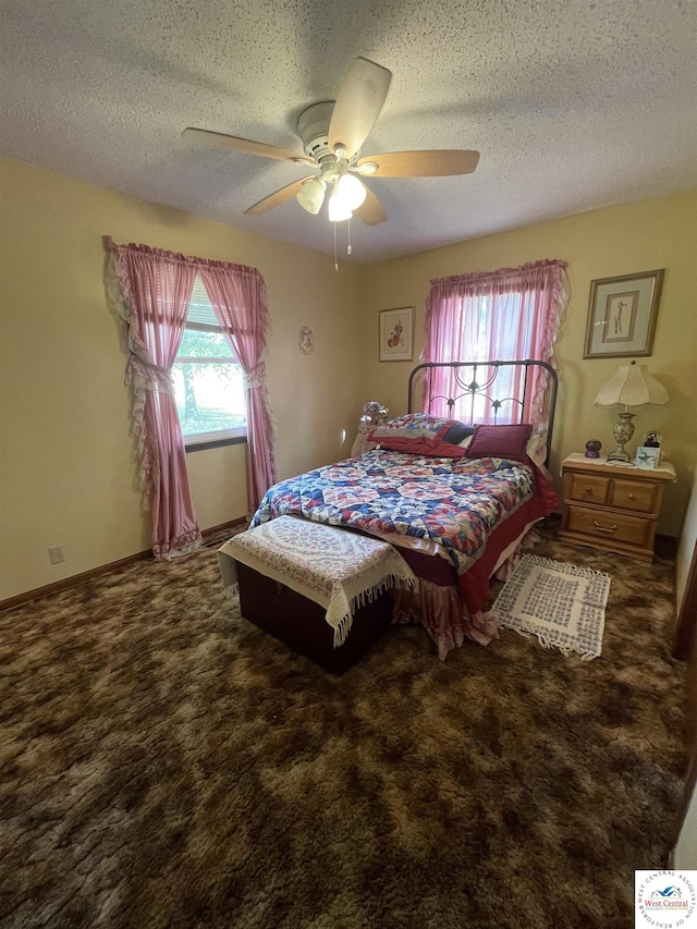 bedroom featuring carpet, ceiling fan, and a textured ceiling