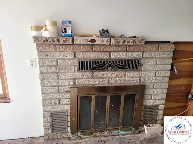 details featuring a fireplace and visible vents