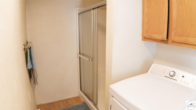 252 Shawn Ave, Lincoln, MO 65338 - laundry room featuring washer / dryer, cabinet space, and light wood-style floors