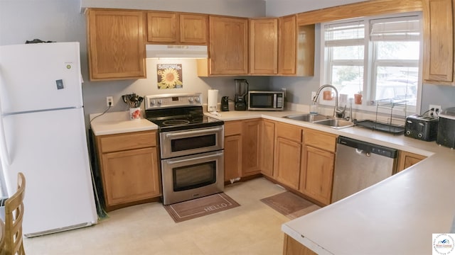 252 Shawn Ave, Lincoln, MO 65338 - kitchen with appliances with stainless steel finishes, under cabinet range hood, a sink, and light countertops