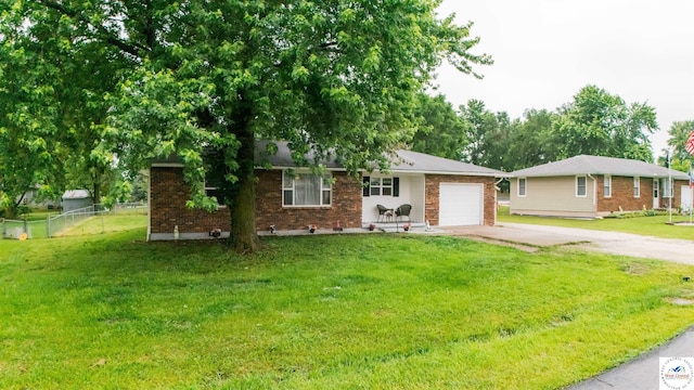 252 Shawn Ave, Lincoln, MO 65338 - ranch-style home with concrete driveway, a garage, and brick siding