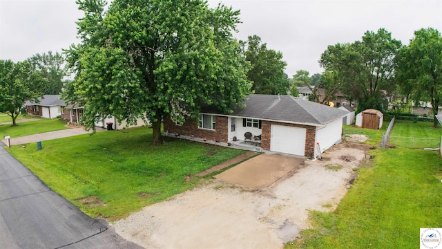 252 Shawn Ave, Lincoln, MO 65338 - view of front of property with brick siding, driveway, a garage, a storage unit, and a front lawn