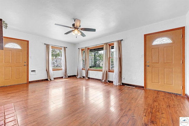 entrance foyer with light wood-style floors, a ceiling fan, and baseboards