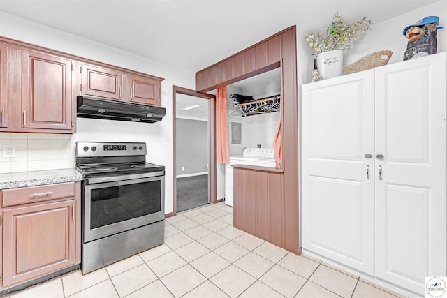 kitchen with electric range, light countertops, decorative backsplash, light tile patterned floors, and under cabinet range hood