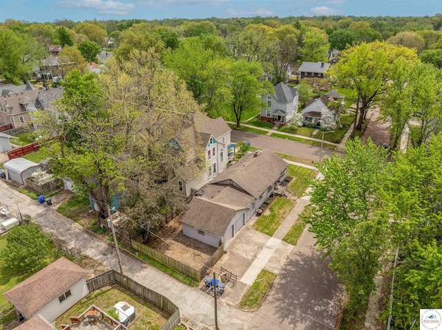 aerial view featuring a wooded view and a residential view