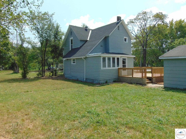 311 N Water St, Clinton, MO 64735 - back of house with a lawn, a chimney, a shingled roof, and a wooden deck
